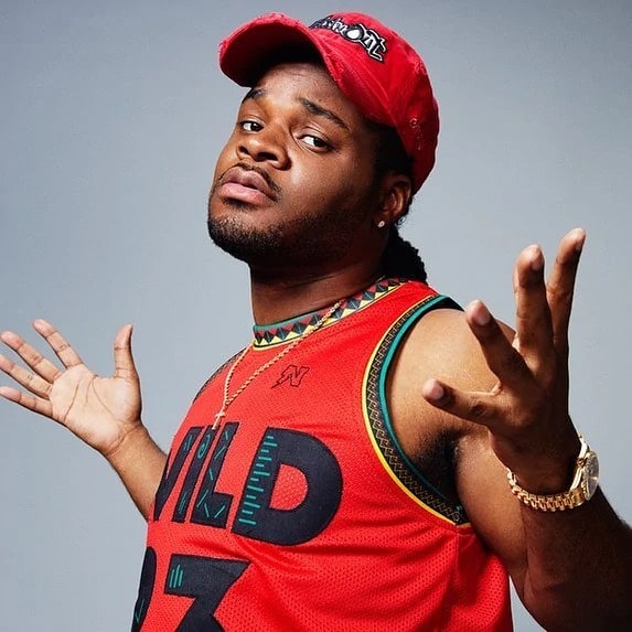 emanhudson is wearing a red jersey and red cap.